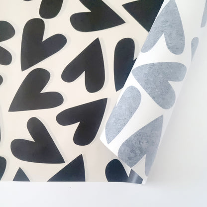 Large hearts printed in black ink on a light beige background on 30gsm white tissue paper.